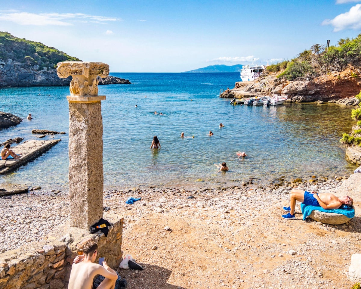 Bathers in the ancient Roman ruins of Cala Maestra, Giannutri Island, Tuscany.