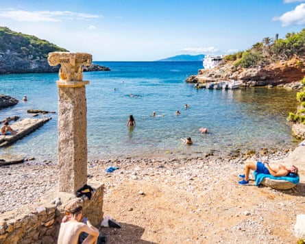 Bathers in the ancient Roman ruins of Cala Maestra, Giannutri Island, Tuscany.