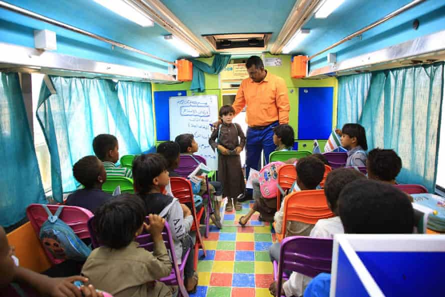Students aboard Edris, the roaming school. The brightly coloured bus is equipped with a computer lab and a library.