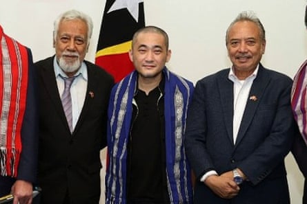Dignitaries in front of flags