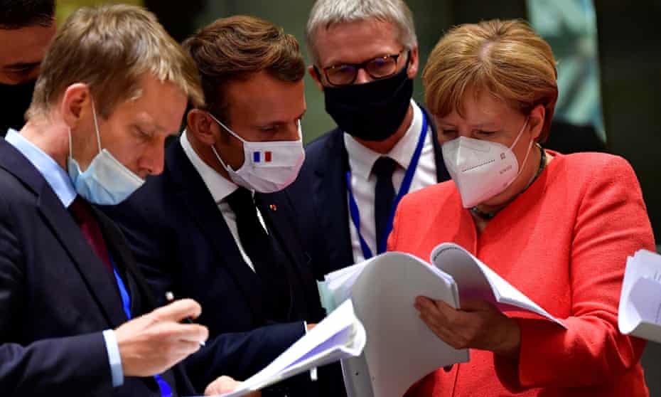 Angela Merkel chats with France’s Emmanuel Macron (second left) at the EU summit on Monday