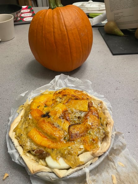 A plate of pompion pye with a pumpkin beside it