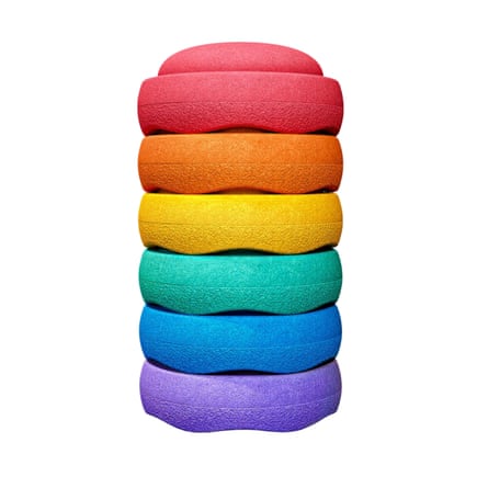 Six round, cushioned stepping stones stacked vertically in rainbow colours against a white background