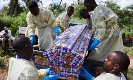 Health workers lift a coffin carrying Kahumbu Ngalyakuthi, who was infected after sharing a hospital room with a patient with Ebola in North Kivu.