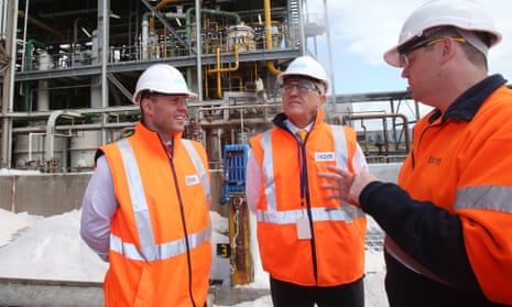 Prime Minister Malcolm Turnbull (centre) and Australian Minister for Energy and the Environment Josh Frydenberg (left) speak to a worker at a plant in Melbourne.