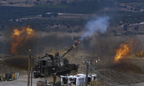 Israeli forces fire artillery from their position on the border with Lebanon after a barrage of rockets were fired from Lebanon.