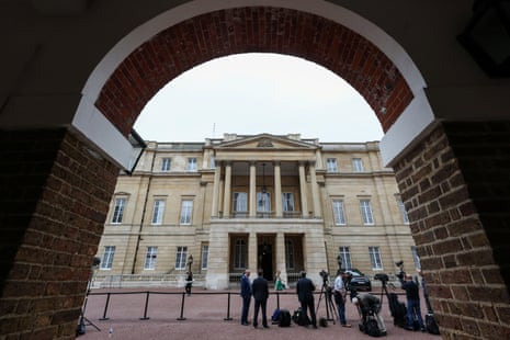 Media members stand outside the Lancaster House