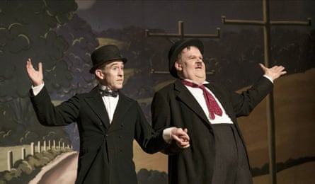 Dressed in dark suits and hats, they hold hands on stage and pose