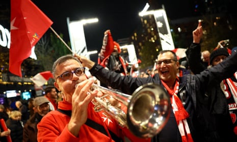 Malta fans, including one playing a trumpet, enjoy themselves outside Wembley Stadium before the Euro 2024 qualifier against England.