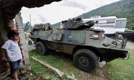A boy looks at a Colombian Army armoured vehicle in Cauca on Wednesday.