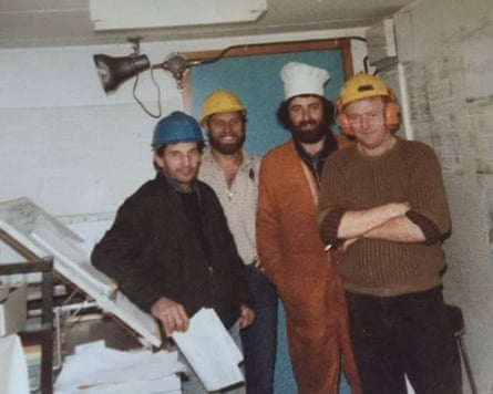 Four men in hard hats on oil rig