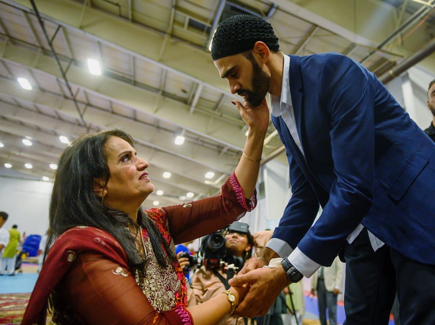 Hamid Hayat, right, is welcomed by the community after making his first public appearance at a news conference that coincided with Eid al-Adha in Sacramento, California, in 2019.