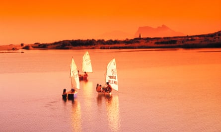 Sailboats in an orange sunset light.
