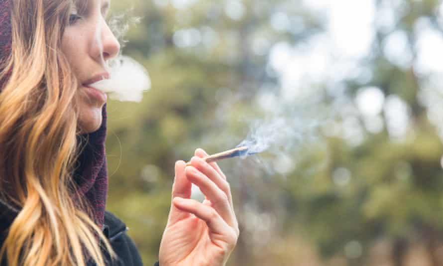 A woman smoking cannabis in Portland, US, where it is legal for recreational use.