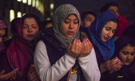 Friends and family members pray at a vigil for Deah Shaddy Barakat, Yusor Mohammad Abu-Salha and Razan Mohammad Abu-Salha, on the campus of North Carolina State University in Raleigh.