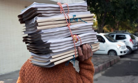 A man carries a pile of documents outside one of the courts in New Delhi, India.