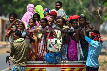 Voters leave on a truck after casting their ballot during the first phase of voting in India’s general election, in Chhattisgarh state