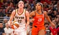 Indiana Fever guard Caitlin Clark (22) drives as Connecticut Sun guard DiJonai Carrington (21) defends in the second half of Monday’s game in Indianapolis.