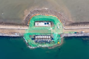 A sea wall under construction near an artificial beach in eastern Tianjin