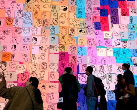 Outernet visitors look at the Royally Big Portrait, a giant digital portrait of King Charles