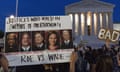 A protesters holds up a sign with pictures of supreme court justices Thomas, Kavanaugh, Samuel Alito, Amy Coney Barrett, and Neil Gorsuch outside the supreme court.