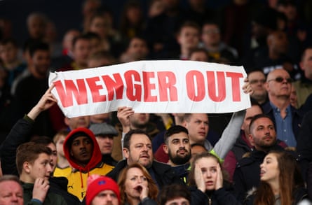Fans hold a 'Wenger Out' banner during the 2014-15 season
