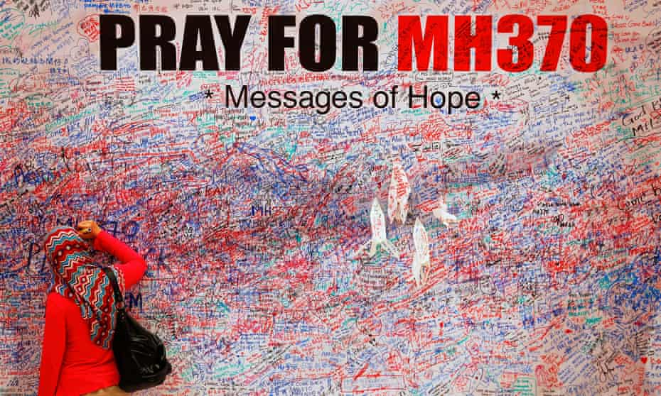 A woman leaves message of support for passengers of missing Malaysia Airlines MH370.