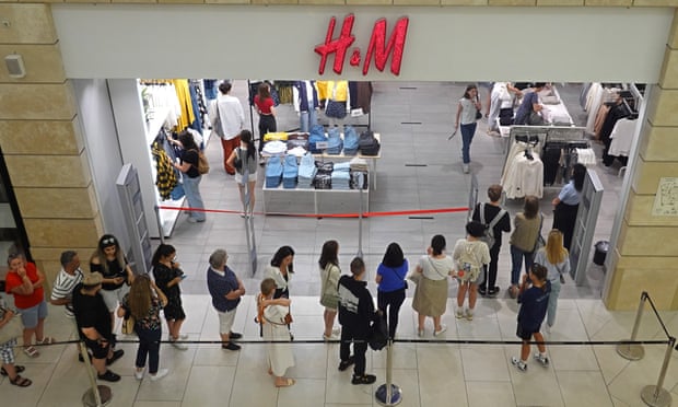 Customers queue outside H&M at the Metropolis shopping mall in Moscow.