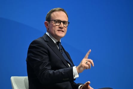 Tom Tugendhat talking against a Tory blue backdrop