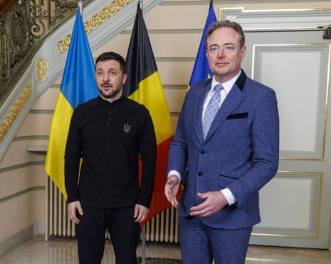 Ukraine's President Volodymyr Zelenskyy (L) poses for the photographers next to Belgium prime minister Bart De Wever prior to a meeting on the sidelines of the Special European Council, at the Belgian PM's office, in Brussels.