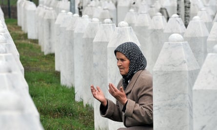 Bida Smajlovic, a survivor of the massacre in Srebrenica, prays by her husband’s grave