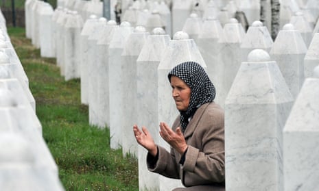 A woman prays at a memorial centre for the victims of the Srebrenica massacre