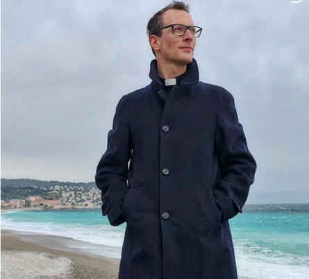 Don Ambrogio Mazzai standing on a beach