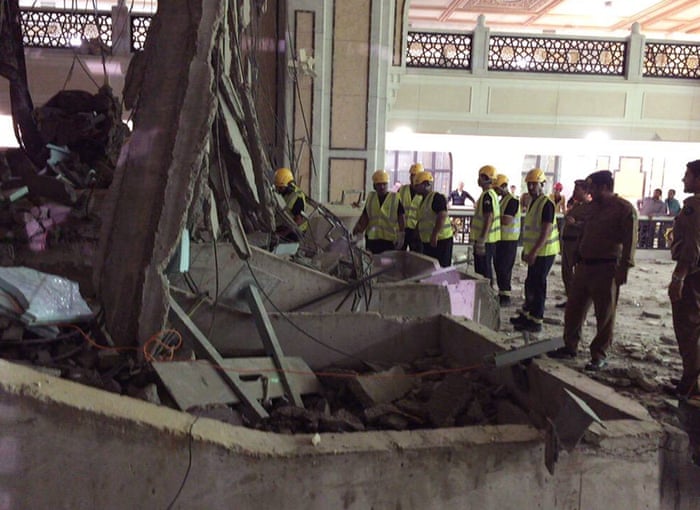 Civil Defence personnel inspect the damage at the Grand Mosque in Mecca.