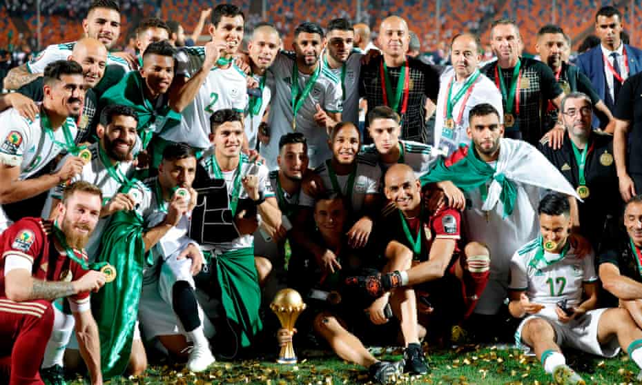 Algeria players and staff celebrate with the trophy in Cairo.