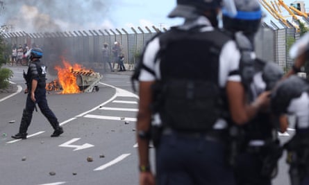 Police officers face demonstrators as people protest against the arrival of the passengers of the Sun Princess cruise ship on the Indian Ocean island of La Reunion without having their temperature checked.