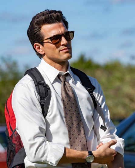 Paul Anthony Kelly wearing a tie, sunglasses and a backpack