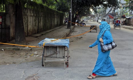 A Bangladeshi woman walks past the site where Cesare Tavella was killed near Dhaka’s diplomatic zone.