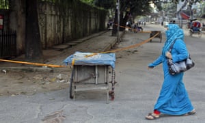 A woman walks past the site where the Italian man Cesare Tavella was shot dead in Dhaka.