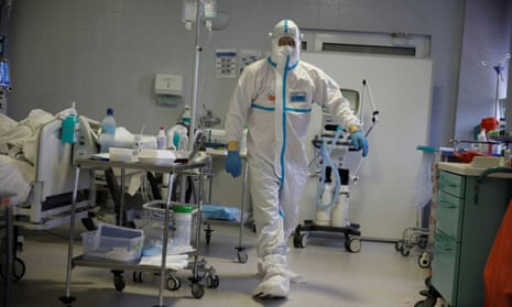 A staff member wears a white hazmat suit and walks across the Covid ward at Warsaw’s Interior Ministry Hospital on 8 November.
