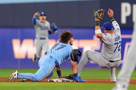 Dodgers second baseman Miguel Rojas (72) fields a throw to force out the Blue Jays' Addison Barger (47) at second to turn a game-ending double play on Friday night.