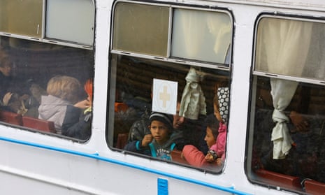 Civilians moved from the Russian-controlled city of Kherson arrive in the town of Oleshky.