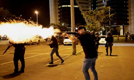 Police clash with supporters of Jair Bolsonaro in Brasília on Monday.