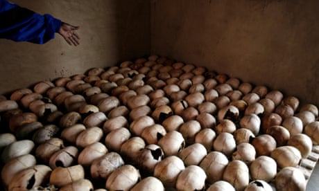 A worker of the Murambi Genocide Memorial shows the skulls of victims of the 1994 genocide, near Butare, Rwanda.
