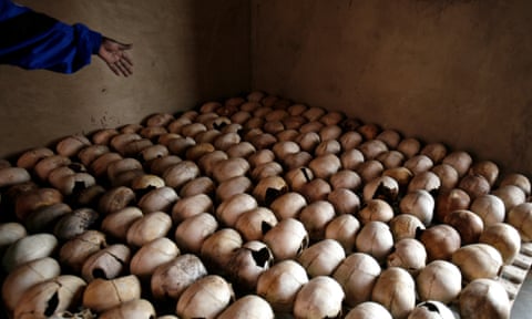 A worker of the Murambi genocide memorial shows the skulls of victims of the 1994 genocide, near Butare, Rwanda.