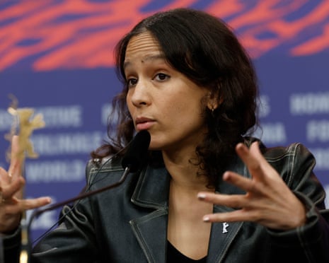 Mati Diop gestures as she speaks at the premiere of her movie at the Berlin film festival