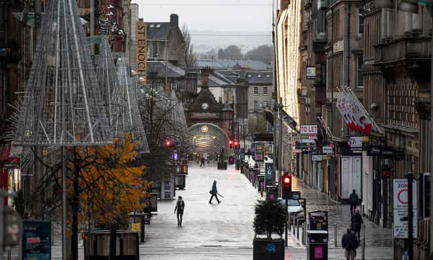 Long shot of a near-deserted street in Glasgow with Christmas decorations