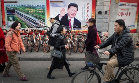 A propaganda poster showing China's President Xi Jinping is displayed on a wall in Beijing