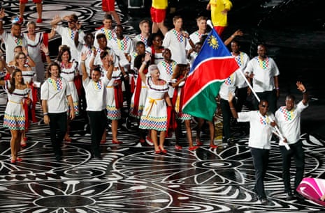 Ananias Shikongo of Namibia carries the national flag.