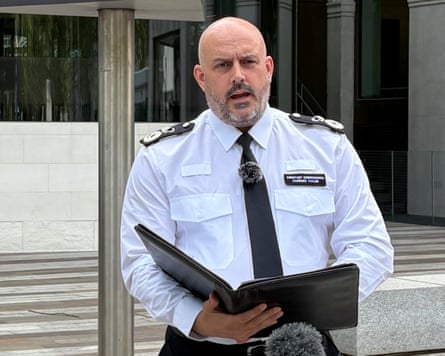 Taylor, holding a black folder, gives a statement